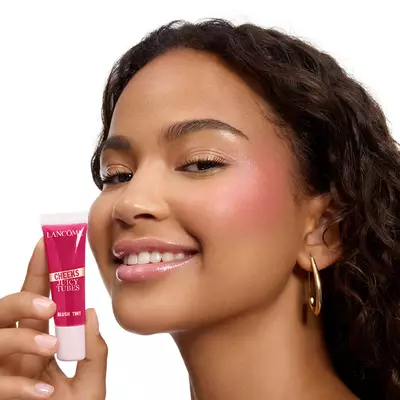 A model holding a Juicy Tube